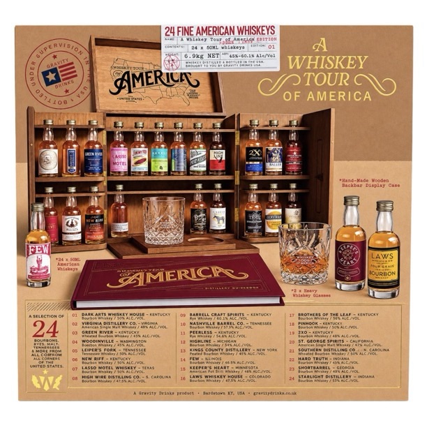 A Whiskey Tour of America first edition gift set open wooden display case with 24 American whiskey 50ml bottles glasses and guidebook