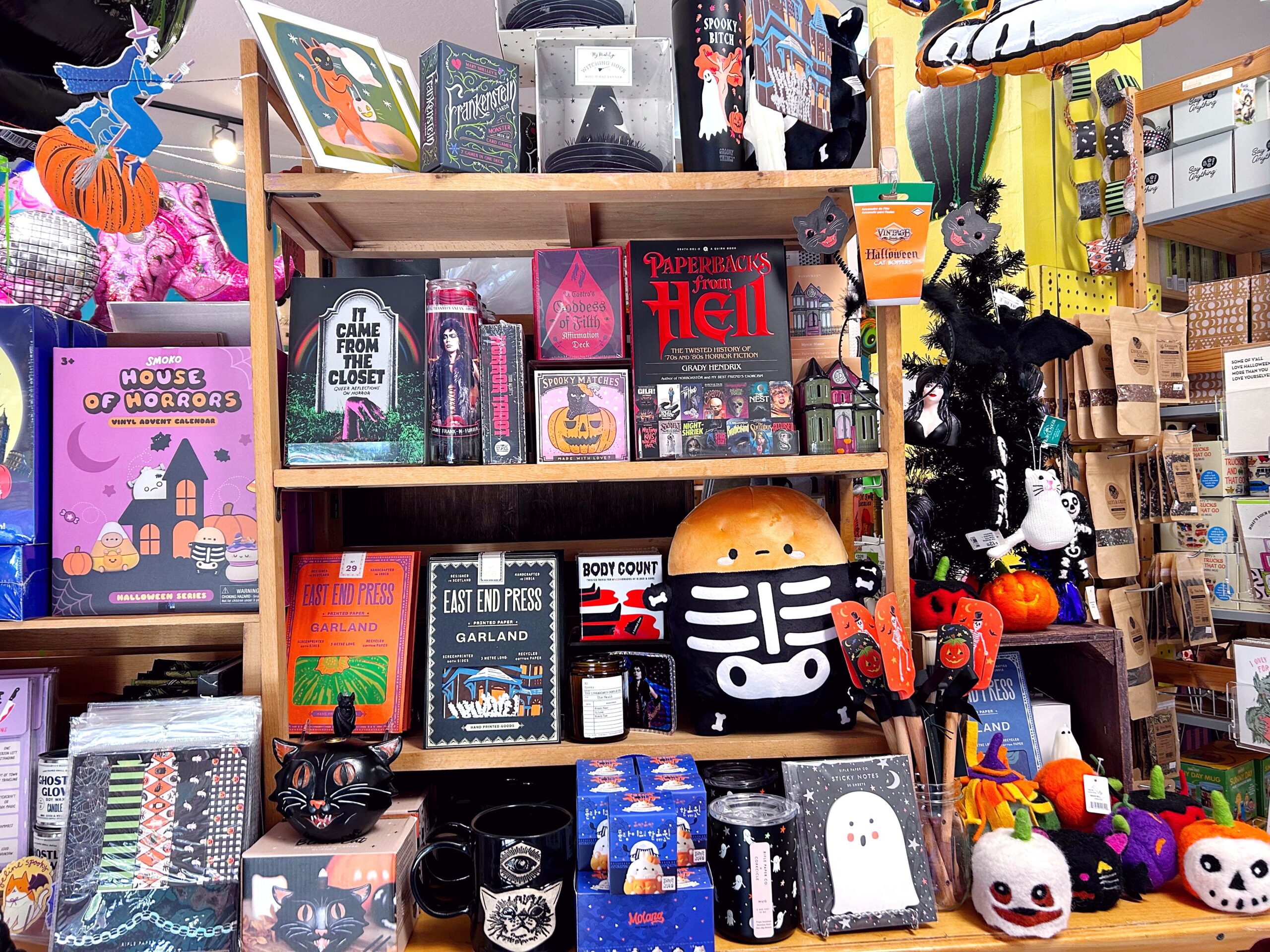 Shelves of Halloween books, decor and gifts at Wild Cat Gift + Party