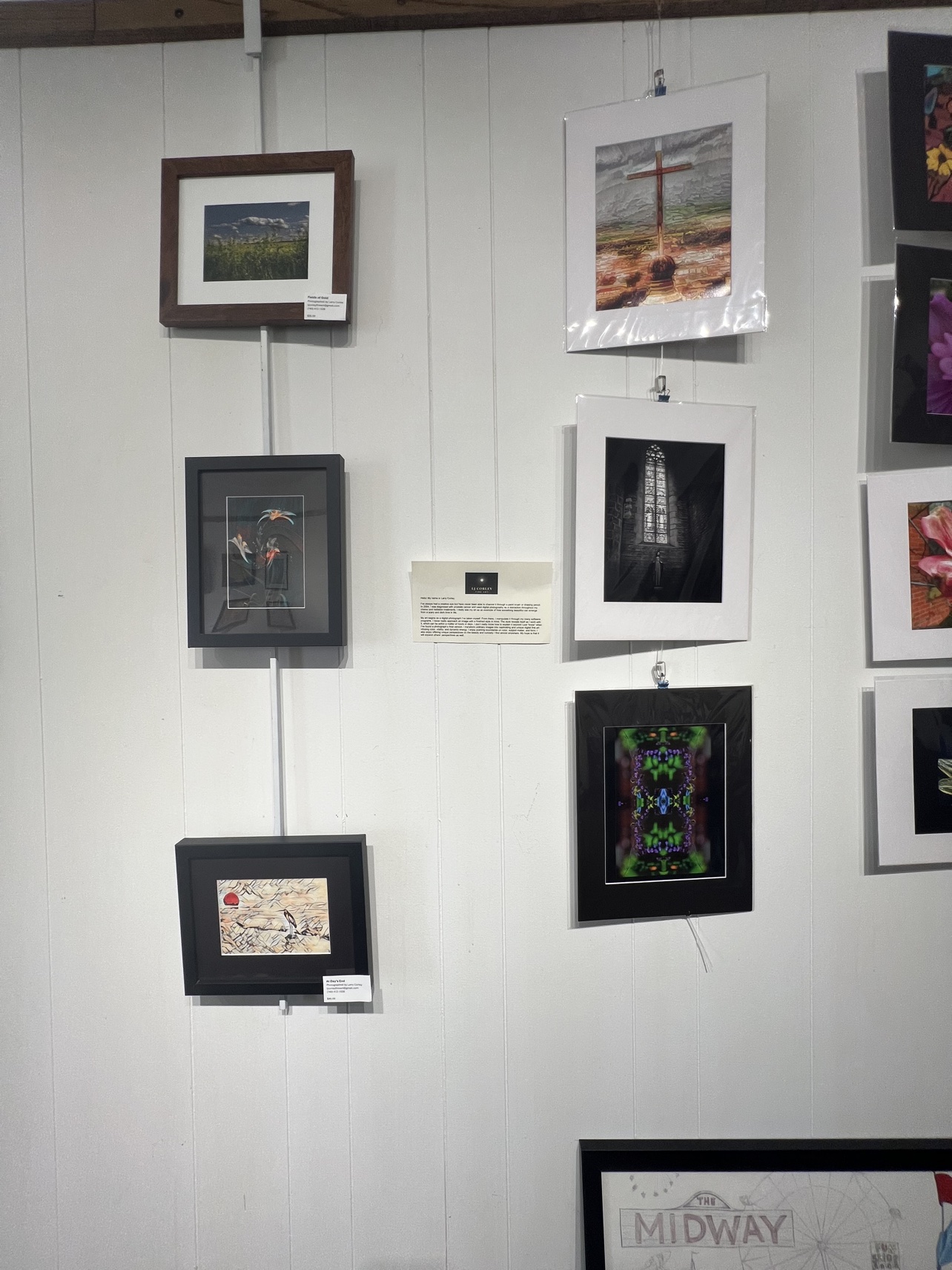 Photography on display, including a cross at sunset and a church window in black and white.