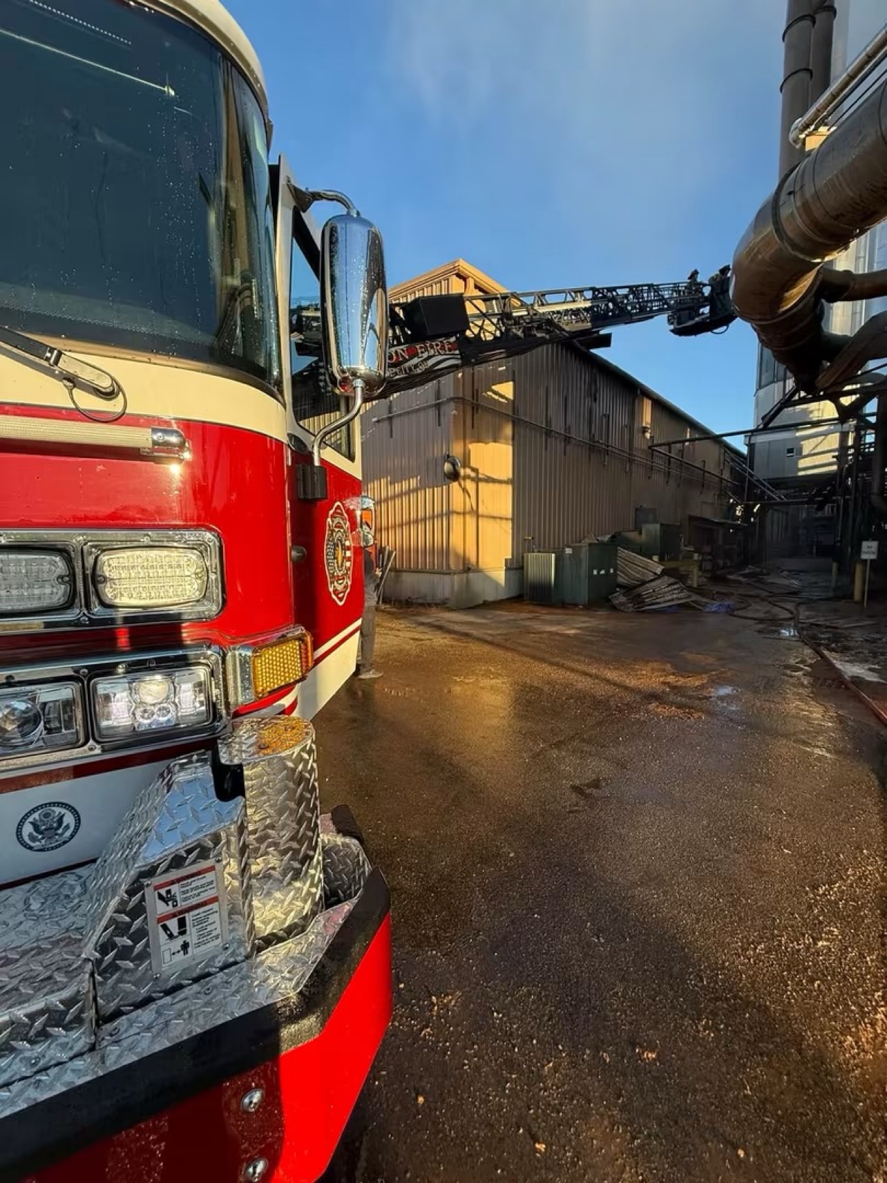 The front of a Jackson Township fire truck at the American Wood Fibers plant in Circleville, with an aerial ladder raised in the background.