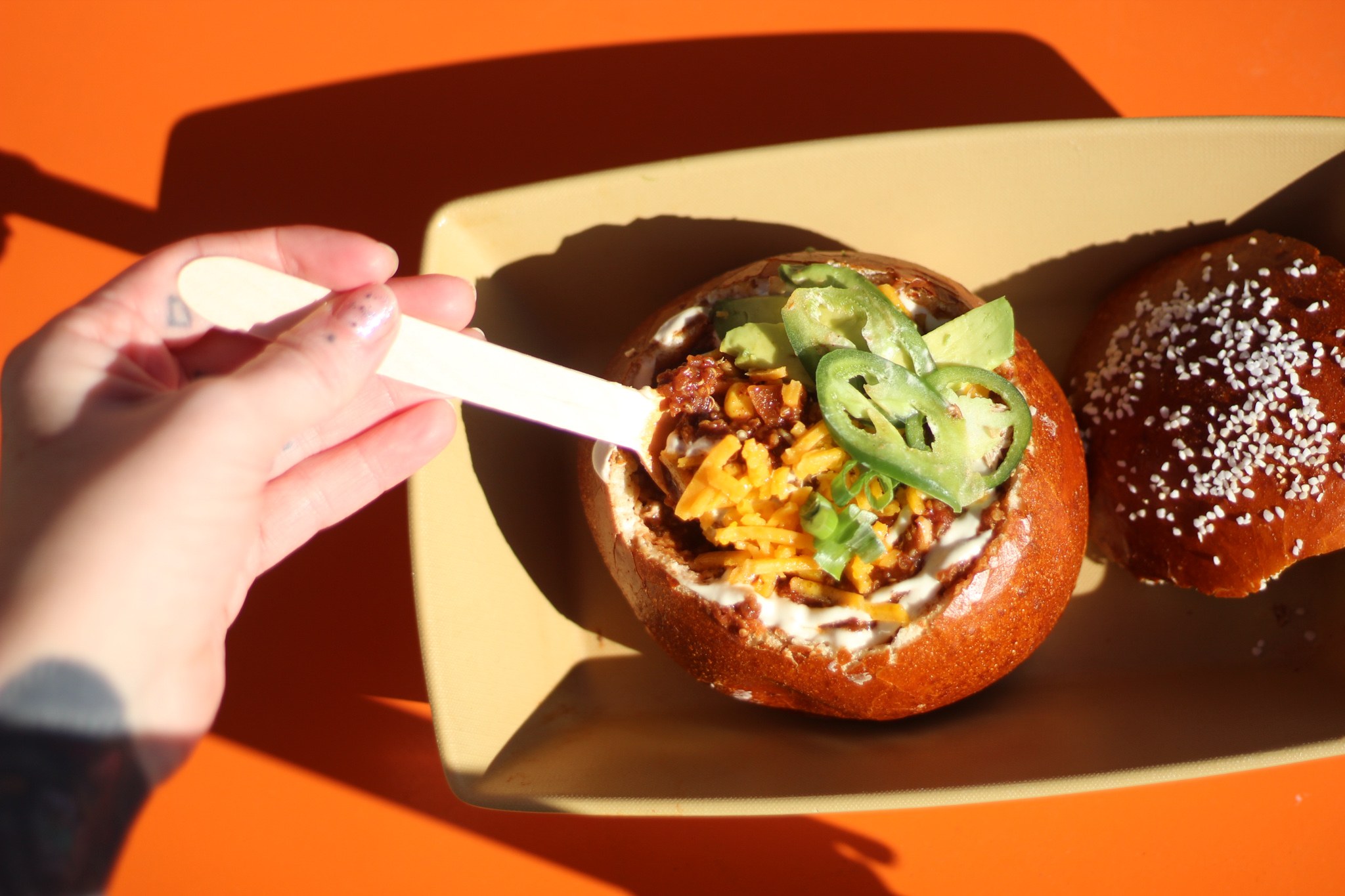 A Brezel pretzel bowl filled with chili, cheese and jalapenos