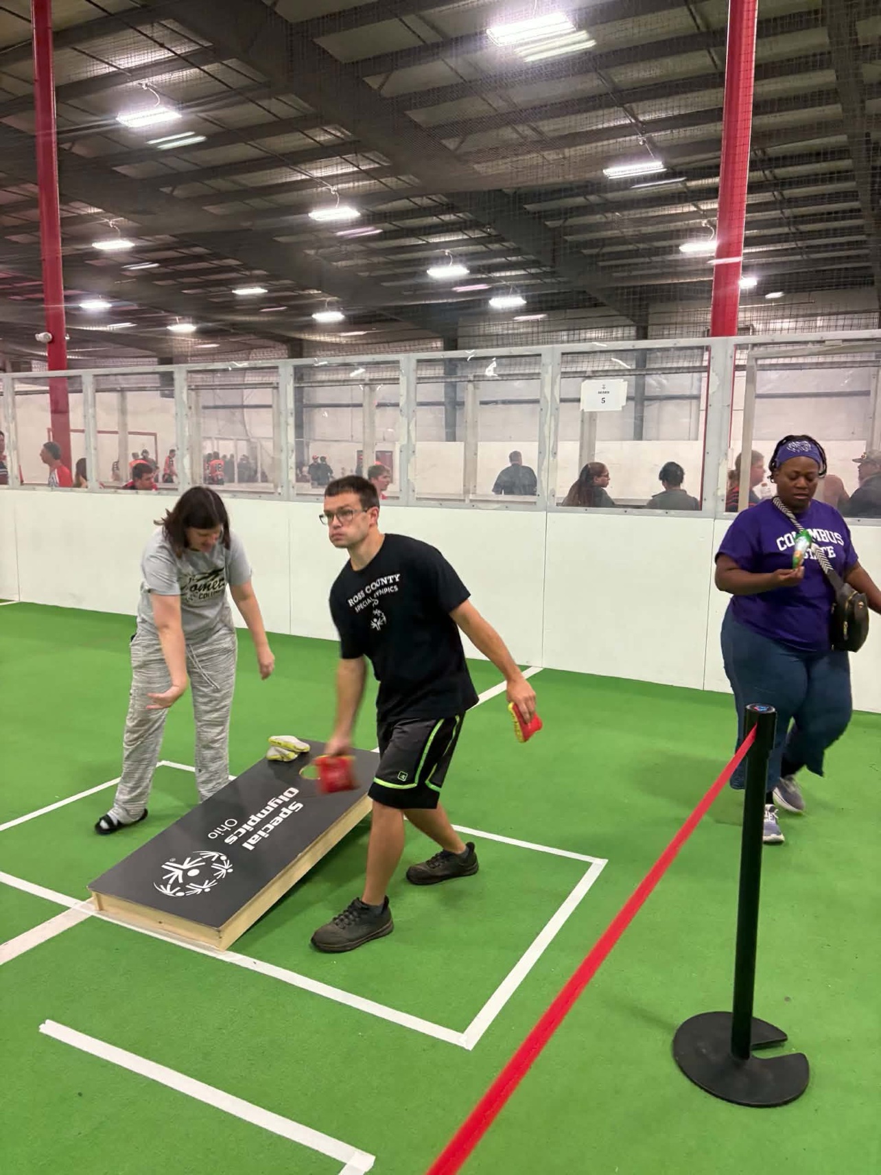 An athlete throws a bag during the state cornhole tournament