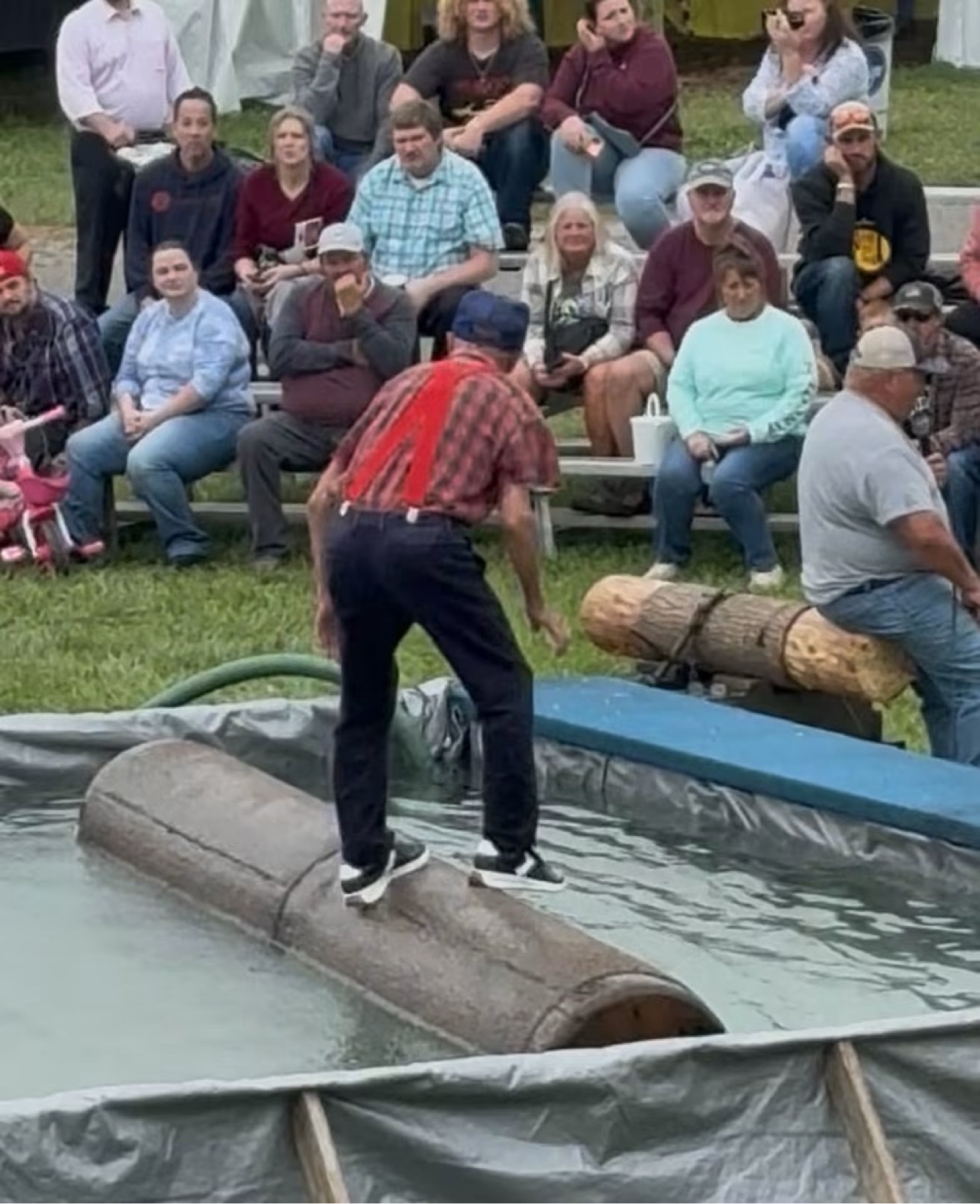 A lumberjack competes in log rolling at the Bob Evans Farm Festival