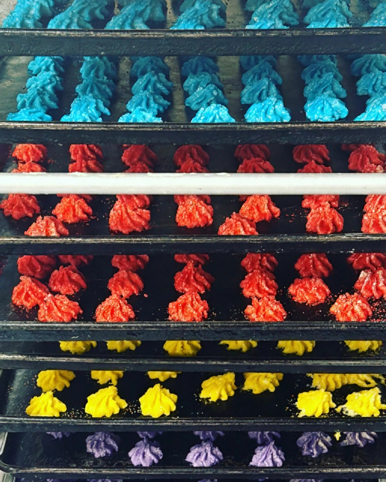 Rows of colorful star and spritz cookies on bakery racks at New System Bakery in Chillicothe