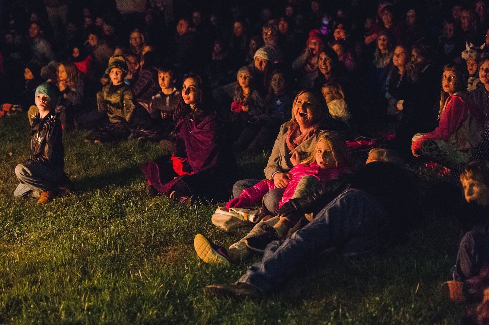 Families watching by firelight at Ohio Village All Hallows Eve