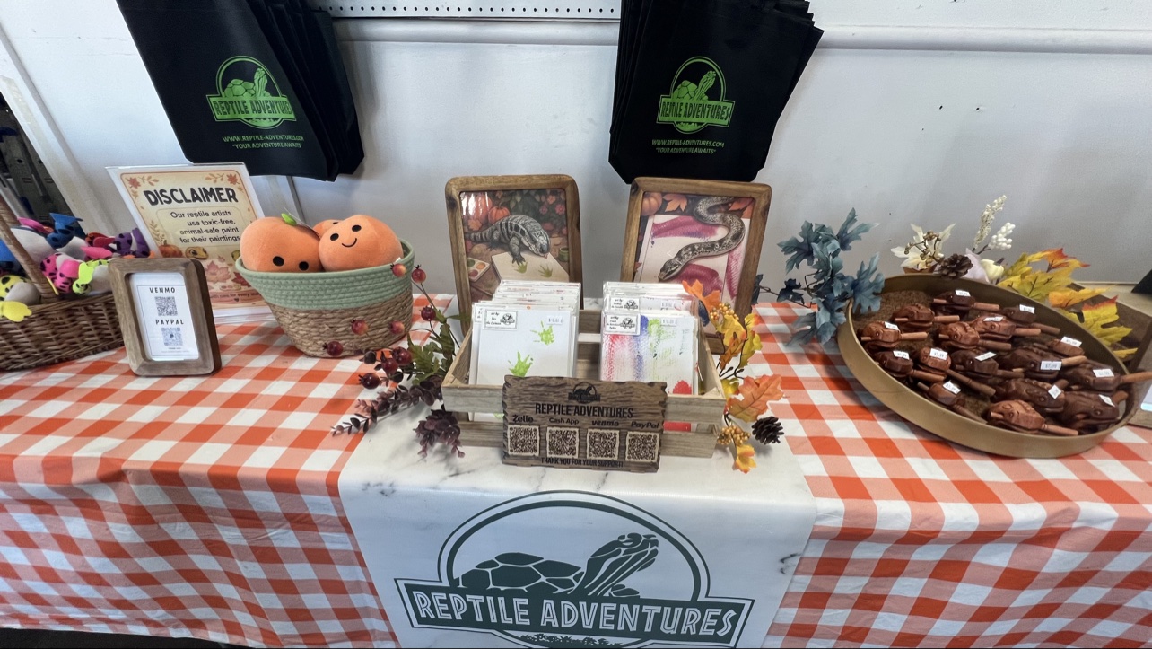 Reptile artwork and merchandise table