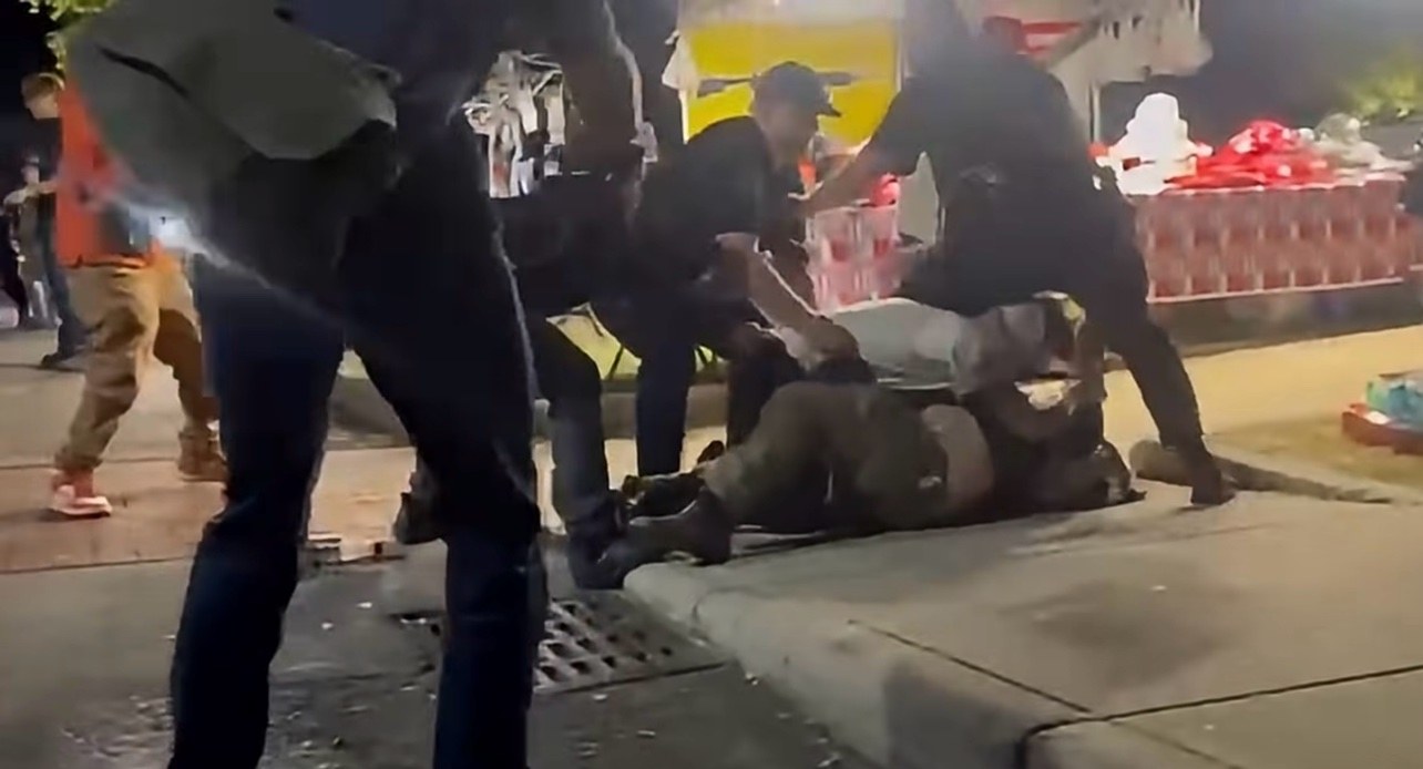 Officers move in to separate two men during a fight outside the Shoemaker Center on Wednesday night.